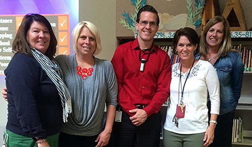 Casey Kannenberg (center) and teachers.