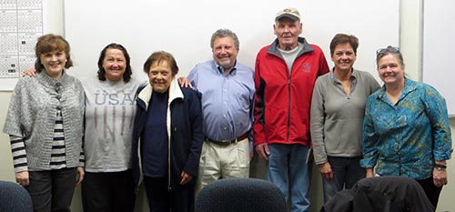 John Sadwith (center) stands with seniors displaced by the Southview Place Towers apartment fire.